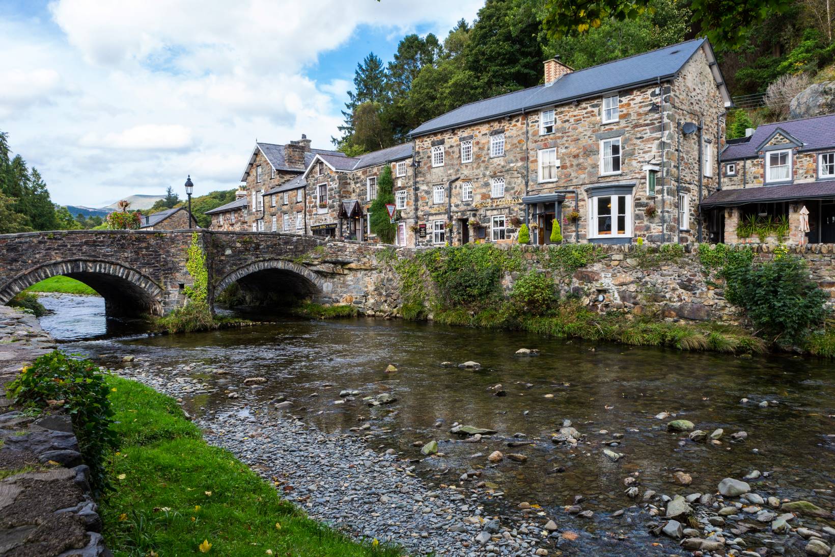 A view of the bridge at the centre of Beddgelert in the summer.