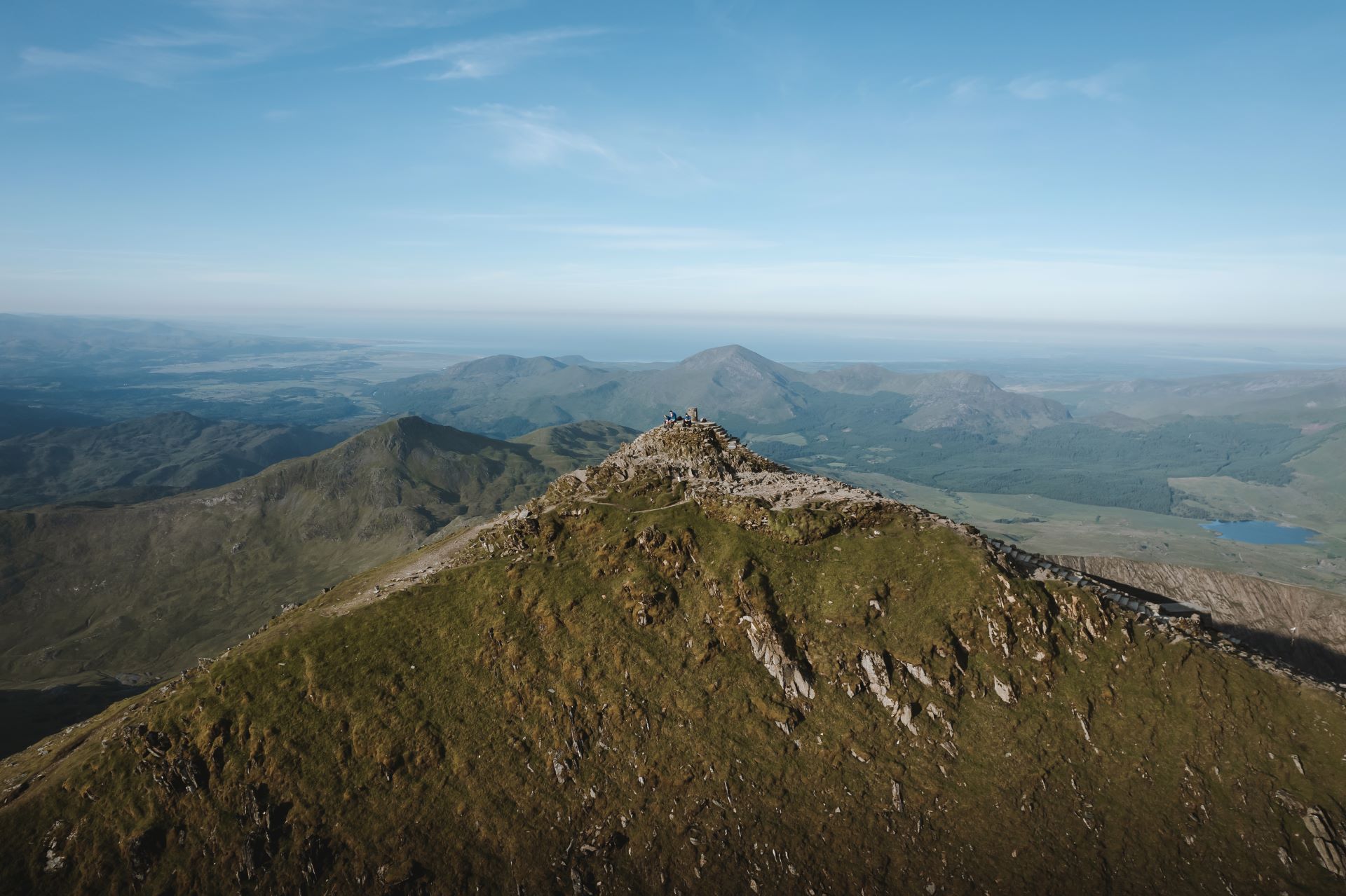Drone photo of Yr Wyddfa's peak on a calm spring day.